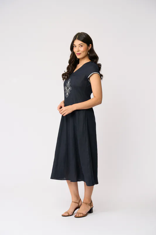 Model wearing True Navy Folk Yeah Dress By Foil Available at Beetees Nelson