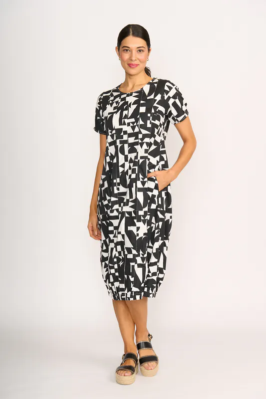 Model wearing Abstract Pleated Maxi Dress By Foil Available at Beetees Nelson
