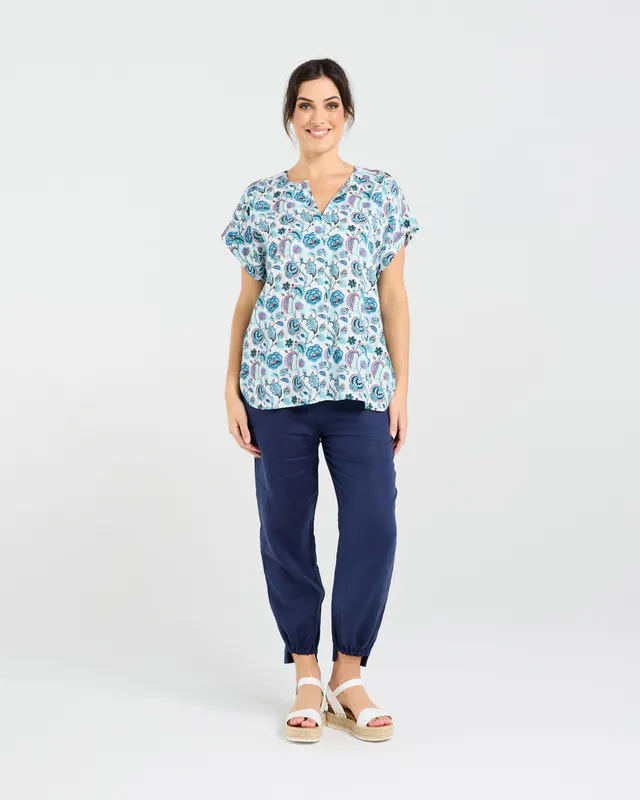 Model wearing Teal Retro Flower Octivia Scoop Hem Top By Blackstone Available at Beetees Nelson