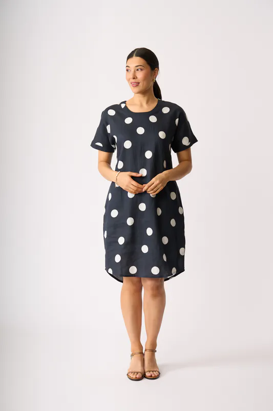 Model wearing True Navy Spot Back Pleat Dress By Foil Available at Beetees Nelson