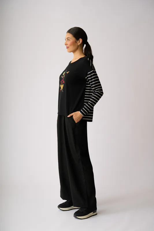 Model wearing Black Sidelines Trousers By Foil Available at Beetees Nelson