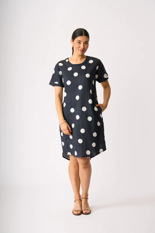 Model wearing True Navy Spot Back Pleat Dress By Foil Available at Beetees Nelson