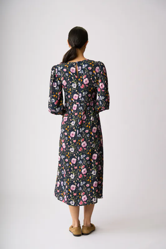 Model wearing Garden Delight Curved & Shirred Dress By Foil Available at Beetees Nelson