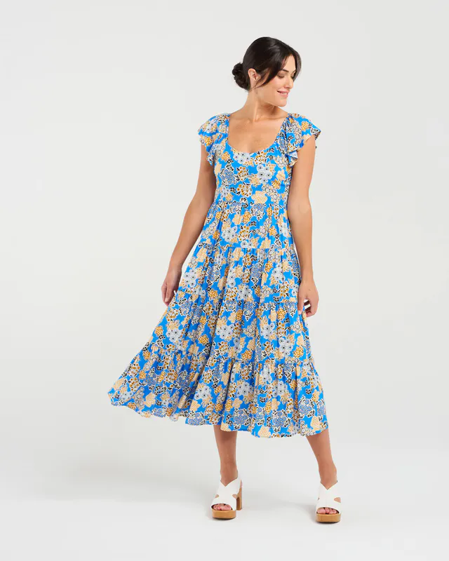Model wearing Blue Bouquet Brielle Flutter Sleeve Dress By Blackstone Available at Beetees Nelson