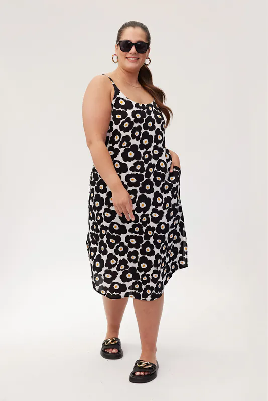 Model wearing Black Daisy Coloured Maddie Dress By Lemon Tree Design Available at Beetees Nelson