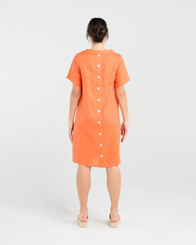 Model wearing Sunset Orange Natacha Linen Button Back Dress By Blackstone Available at Beetees Nelson