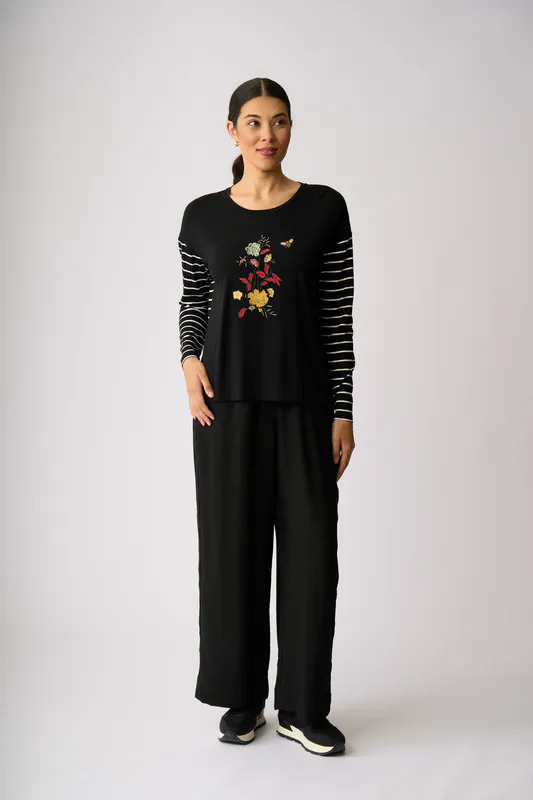 Model wearing Black Sidelines Trousers By Foil Available at Beetees Nelson