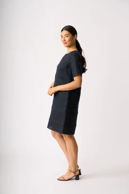 Model wearing True Navy Crowd Favourite Dress By Foil Available at Beetees Nelson
