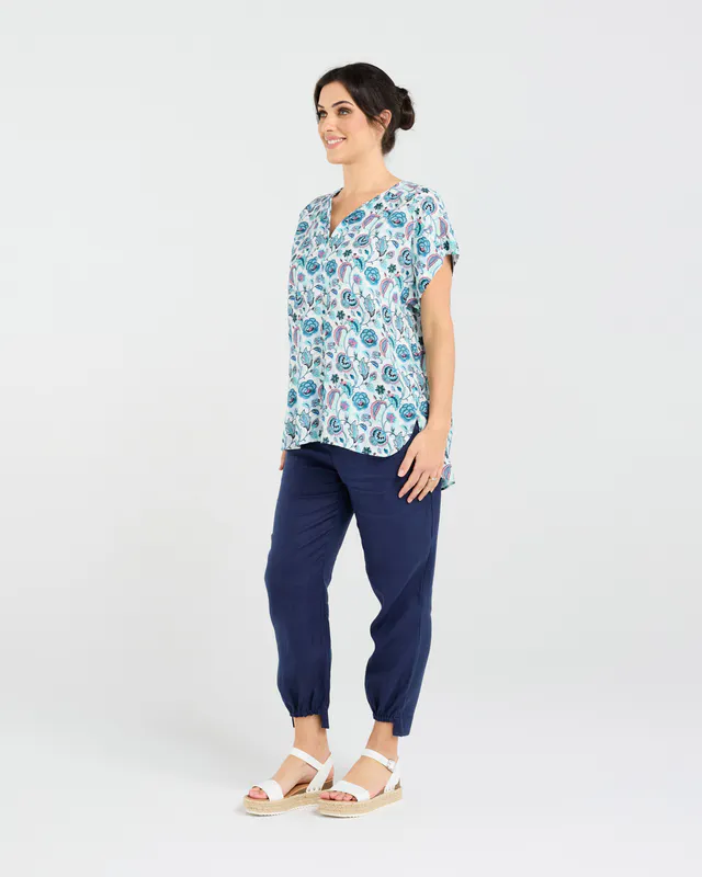 Model wearing Teal Retro Flower Octivia Scoop Hem Top By Blackstone Available at Beetees Nelson