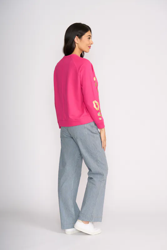 Model wearing Electric Fuchsia Notch Detail Sweatshirt By Foil Available at Beetees Nelson