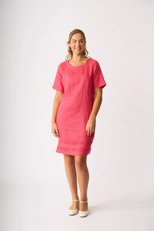 Model wearing Coral Crowd Pleaser Dress By Foil Available at Beetees Nelson