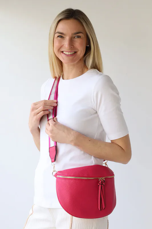 Model wearing Cerise Cross Body Zip Detail Bag By Archer House Available at Beetees Nelson
