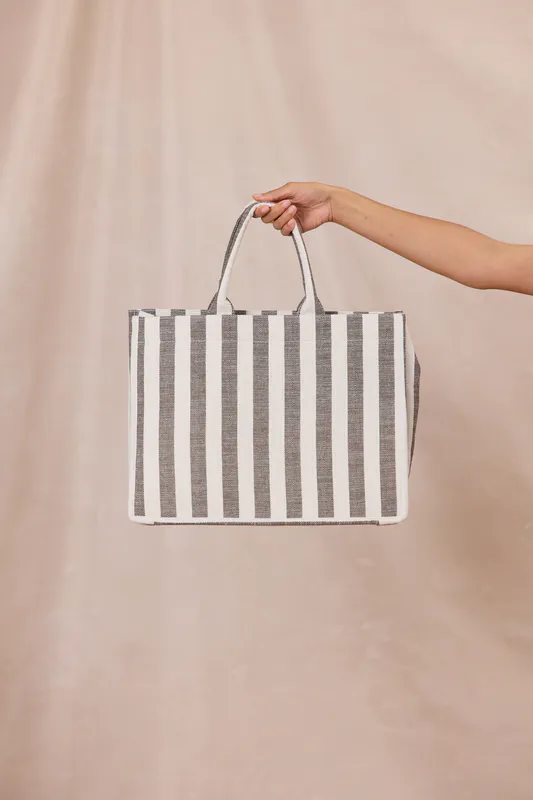 Model wearing Cocoa Stripe Breeze Tote Bag By Design Nation Available at Beetees Nelson