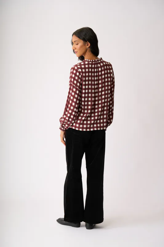 Model wearing Cocoa Check Elasticated Cuff Blouse By Foil Available at Beetees Nelson