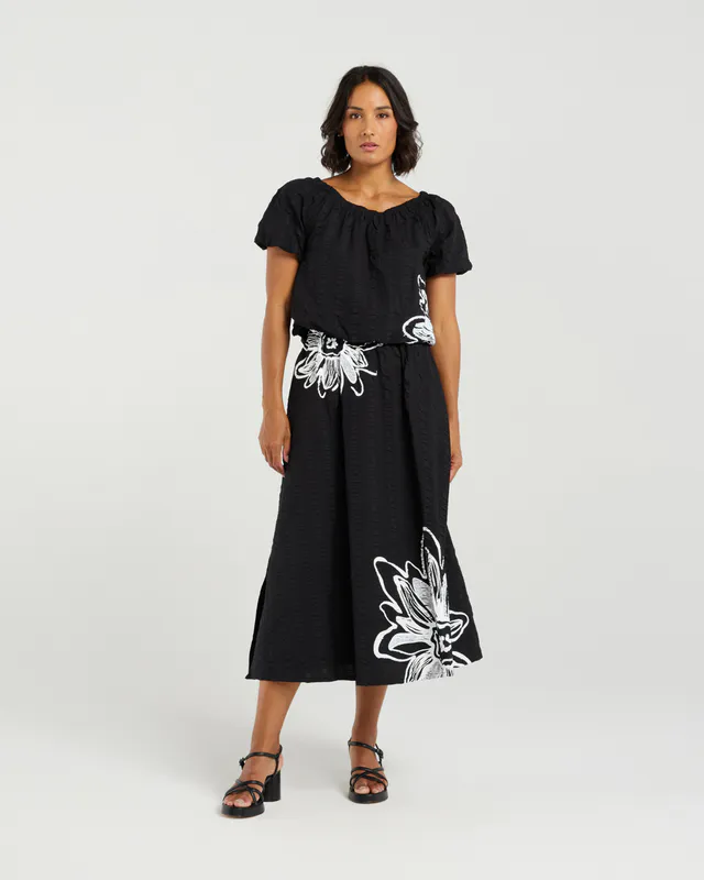Model wearing Black Bloom Daisy Skirt By Et Alia Available at Beetees Nelson