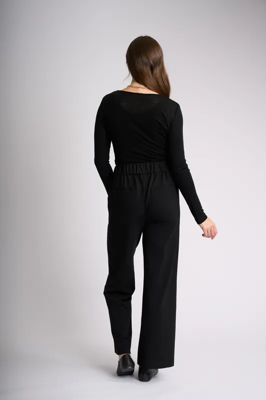 Model wearing Black Essential Crew Neck Top By Foil Available at Beetees Nelson