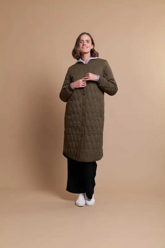 Model wearing Olive Coloured Coat - Quilted Snap By Foil Available at Beetees Nelson