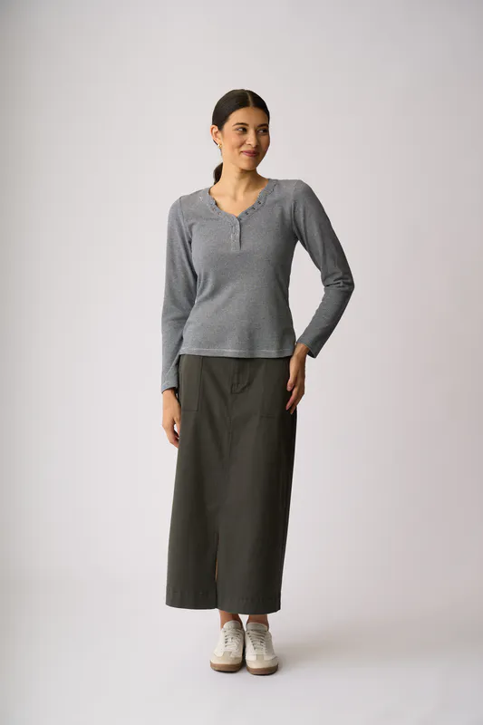 Model wearing Navy Snappy V Henley Top By Esplanade Available at Beetees Nelson