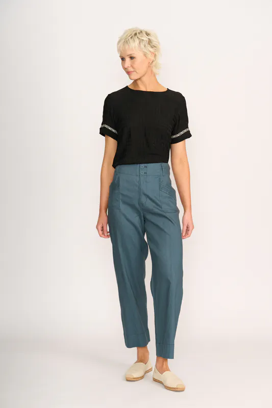 Model wearing Steel Wide Leg Contrast Stitch Trousers By Oh Three Available at Beetees Nelson