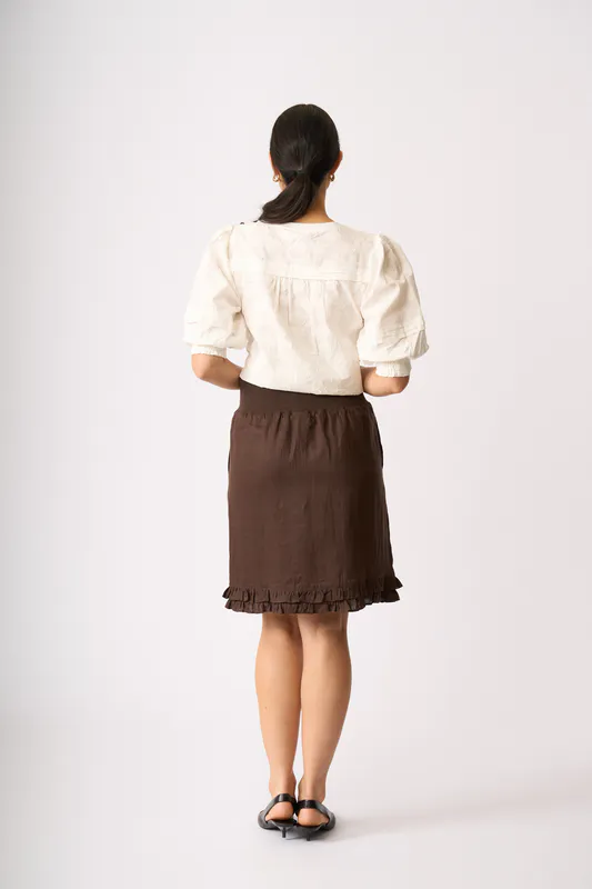 Model wearing Cocoa Ruffle Dreams Skirt By Foil Available at Beetees Nelson