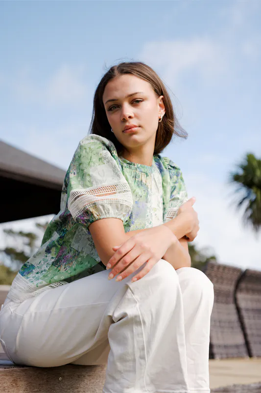 Model wearing Botanical Patch Paige Top By NMBR Rose Available at Beetees Nelson