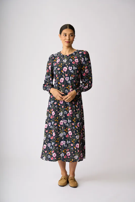 Model wearing Garden Delight Curved & Shirred Dress By Foil Available at Beetees Nelson