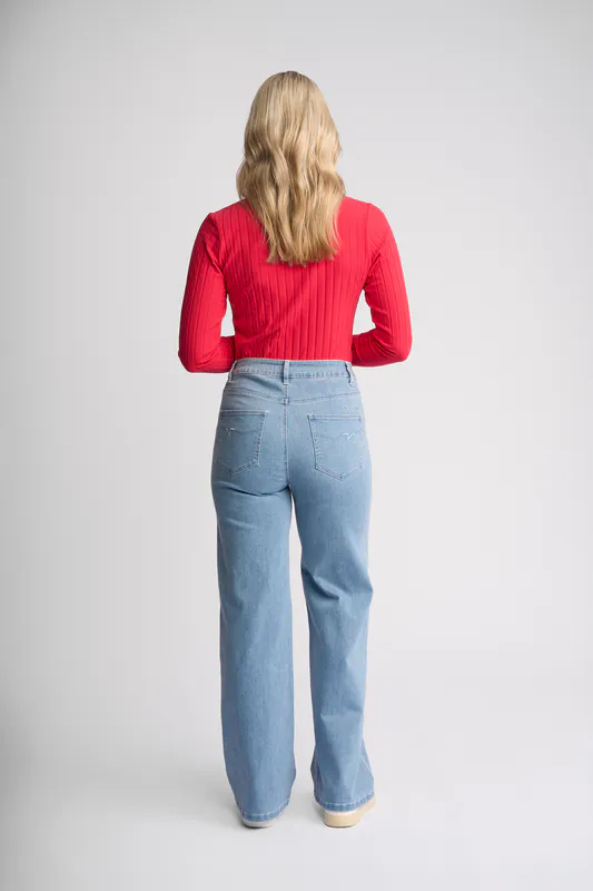 Model wearing Light Wash Denim Lottie Jean By Vassalli Available at Beetees Nelson