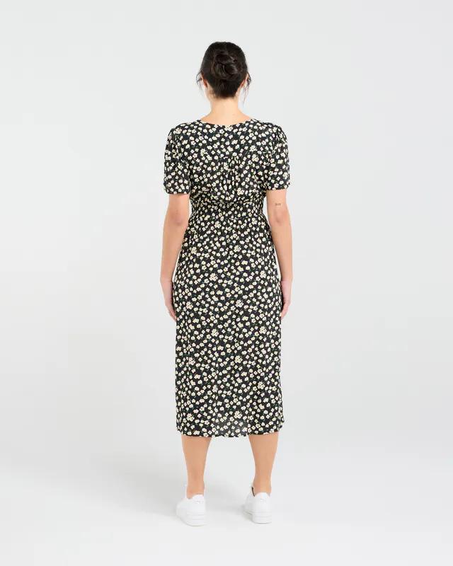 Model wearing Daisy Chain Print Gigi V-neck Button Front Dress By Blackstone Avaialble at Beetees Nelson