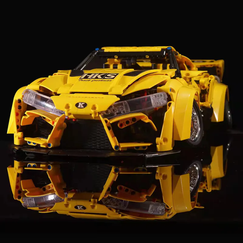 The yellow sports car is a sleek and vibrant model constructed entirely out of building blocks. It comes equipped with a battery-powered engine and advanced remote control features