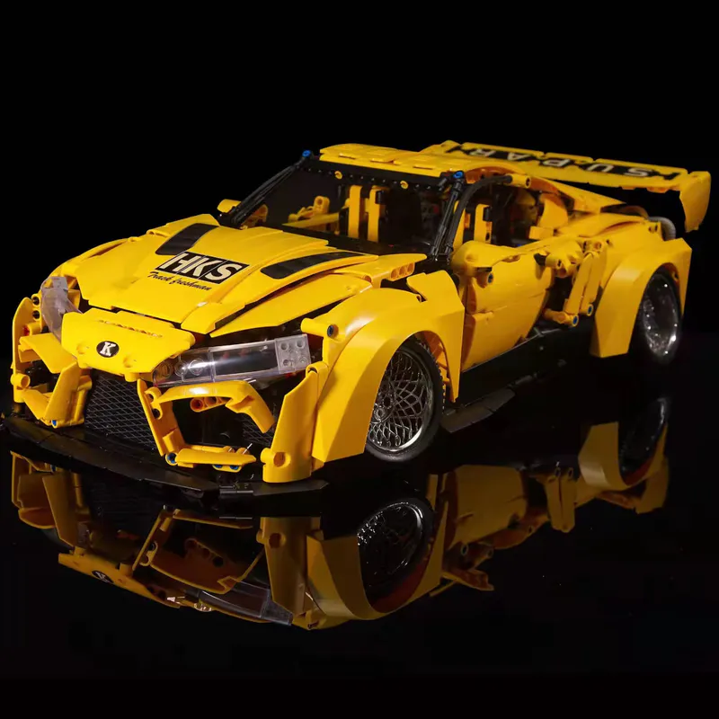 The yellow sports car is a sleek and vibrant model constructed entirely out of building blocks. It comes equipped with a battery-powered engine and advanced remote control features