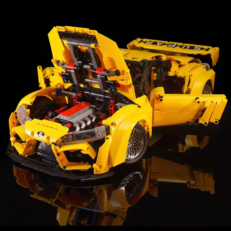 The yellow sports car is a sleek and vibrant model constructed entirely out of building blocks. It comes equipped with a battery-powered engine and advanced remote control features