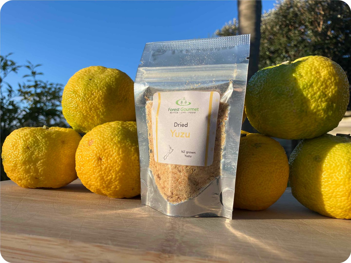 Dried yuzu packet beside fresh yuzu fruit