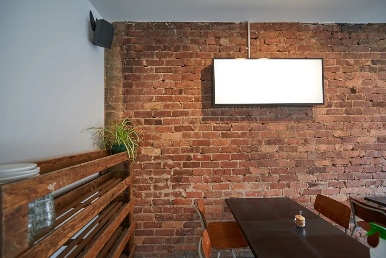 Hello Friends + Allies Cafe original brick wall