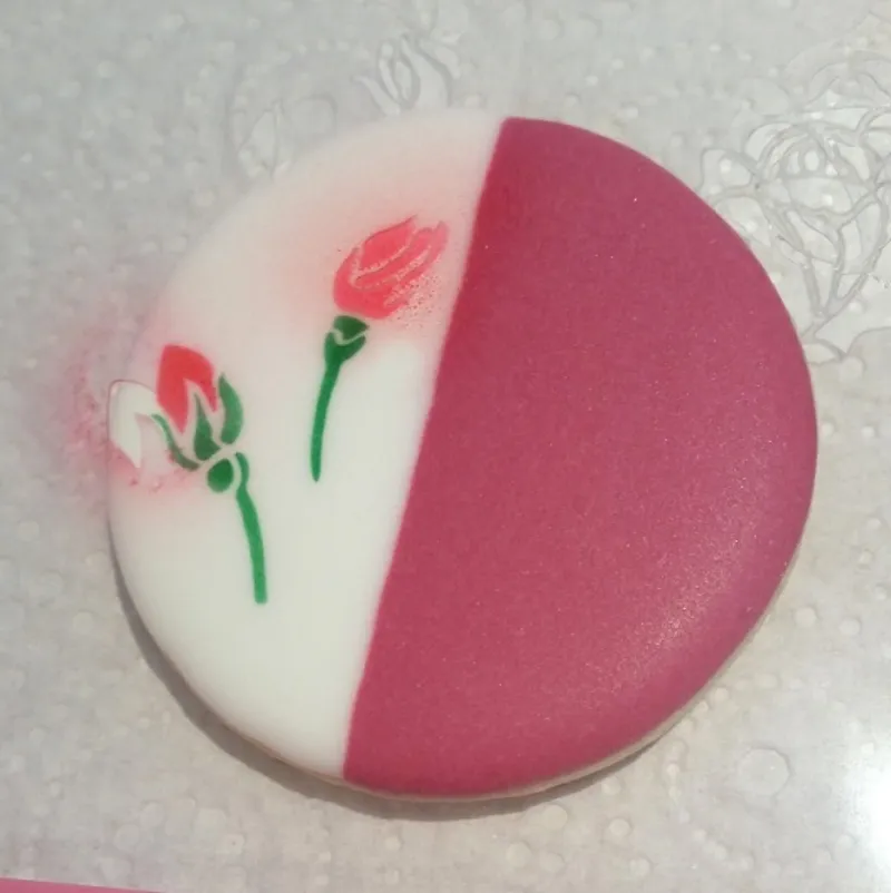 Adding rosebuds to a cookie - the stencil is moved for each part