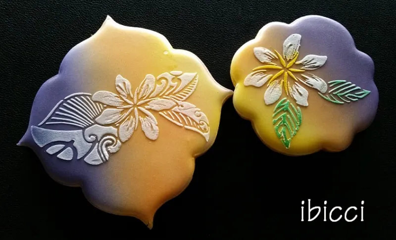 Although not on a cake, these cookies show the 2 flower designs stencilled