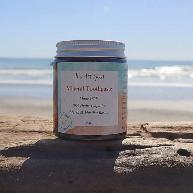 jar of toothpaste in front of the beach