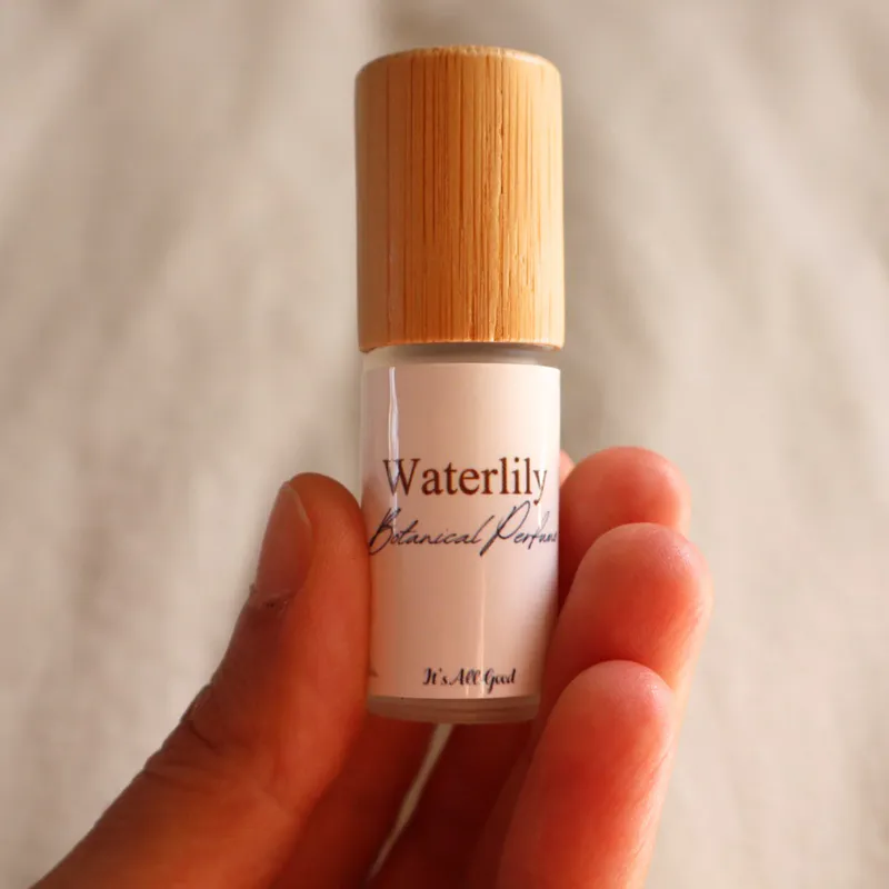A person holding a bottle of Waterlily botanical perfume