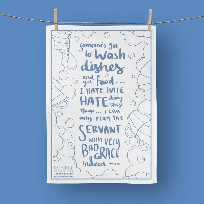 KMHG quote tea towel hanging on a line with wooden pegs