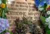 Flowers surround the original plaque from the 1933 Memorial installed by Katherine's father Harold Beauchamp.