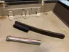 The cleaning brush and oil vial