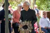 Witi lays the wreath created by Erin Banks which includes dried hydrangeas, silver birch, leucadendron, kānuka, gypsophila and wattle.