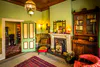 The Drawing Room at Katherine Mansfield House & Garden, photographed by Rob Suisted, 2023. Since this photo was taken, faux ferns have been added to the jardinières in front of the fireplace.