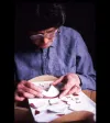 Volunteer Beverley Bruce reconstructing fragments of a maroon-banded saucer.