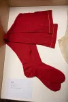 A pair of red stockings displayed in a display case
