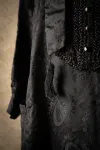 Detail of black dress with beading and tassle