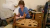 Nicky Neiman stripping furniture in the workshop