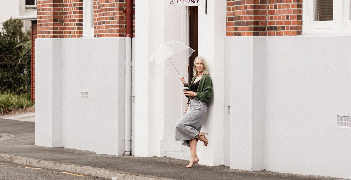 A woman wearing the Gather Sleeve Cardigan pattern by Purl Foundry