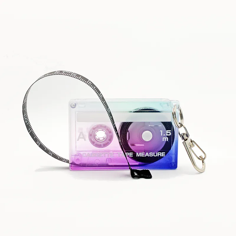 A tape measure in the shape of an 80s cassette tape. It's an ombre colour from purple at the bottom to blue at the top.