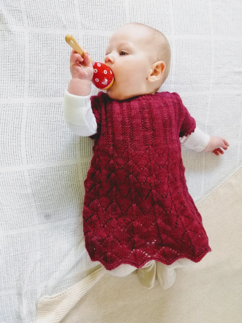 Baby wearing a deep red Pelongpelong dress