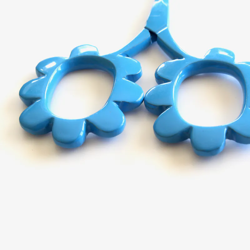 Close up of blue, flower shaped scissors